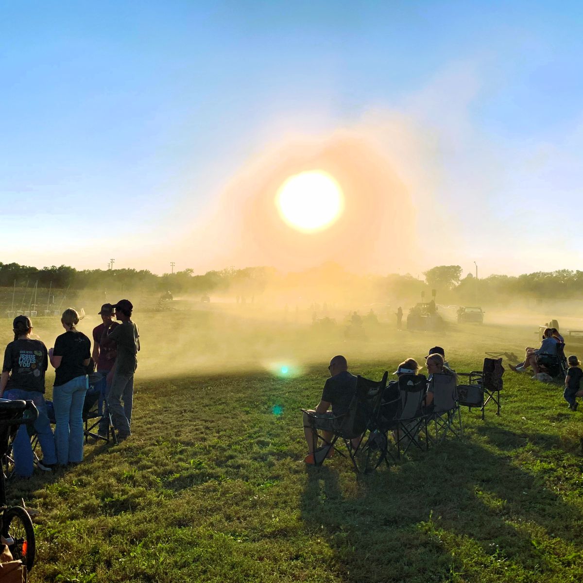dust filled sky with a crowd gathered to watch the ATV races/rodeo