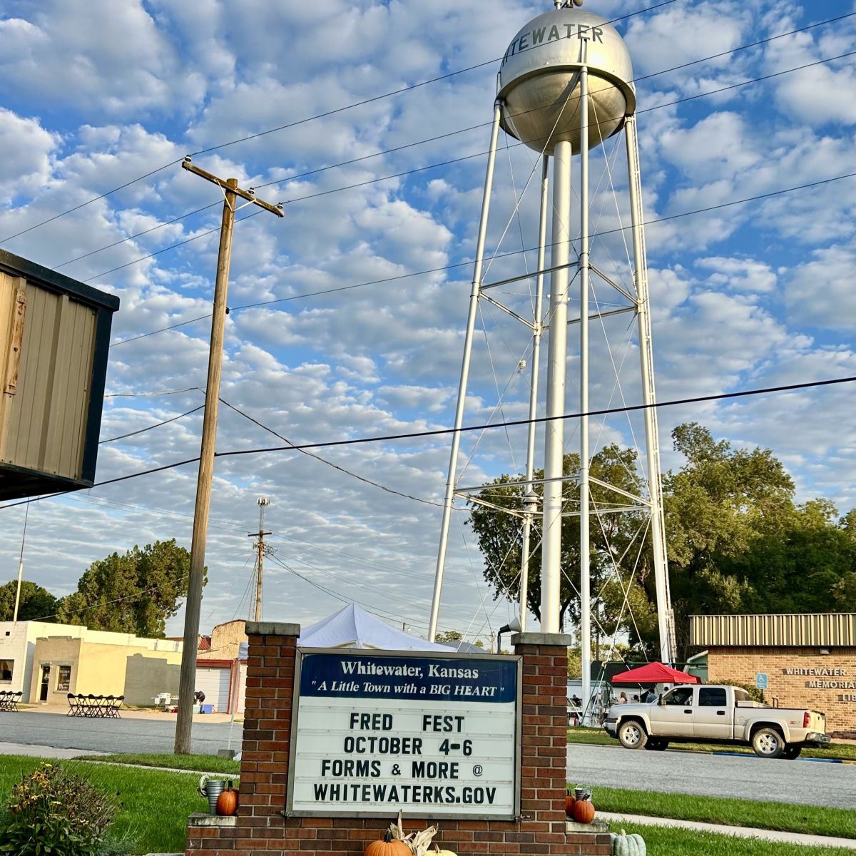 City Sign and Water Tower saying its Fred Fest Time