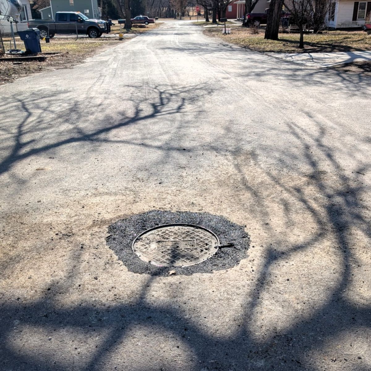 found manhole was raised and patched for access