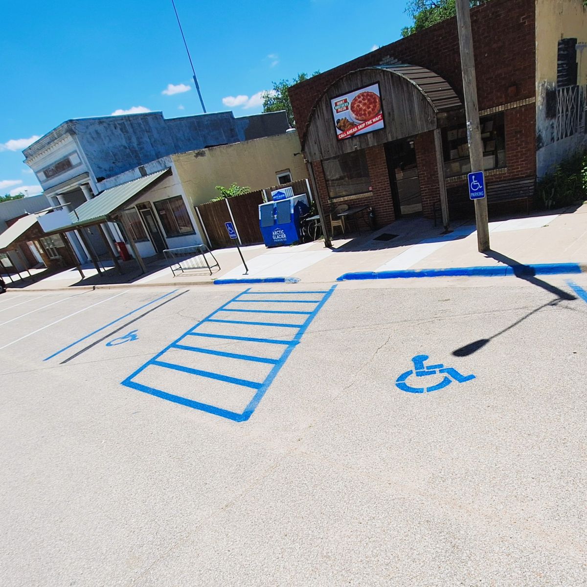 blue handicap spaces marked in front of the Pizza Parlor