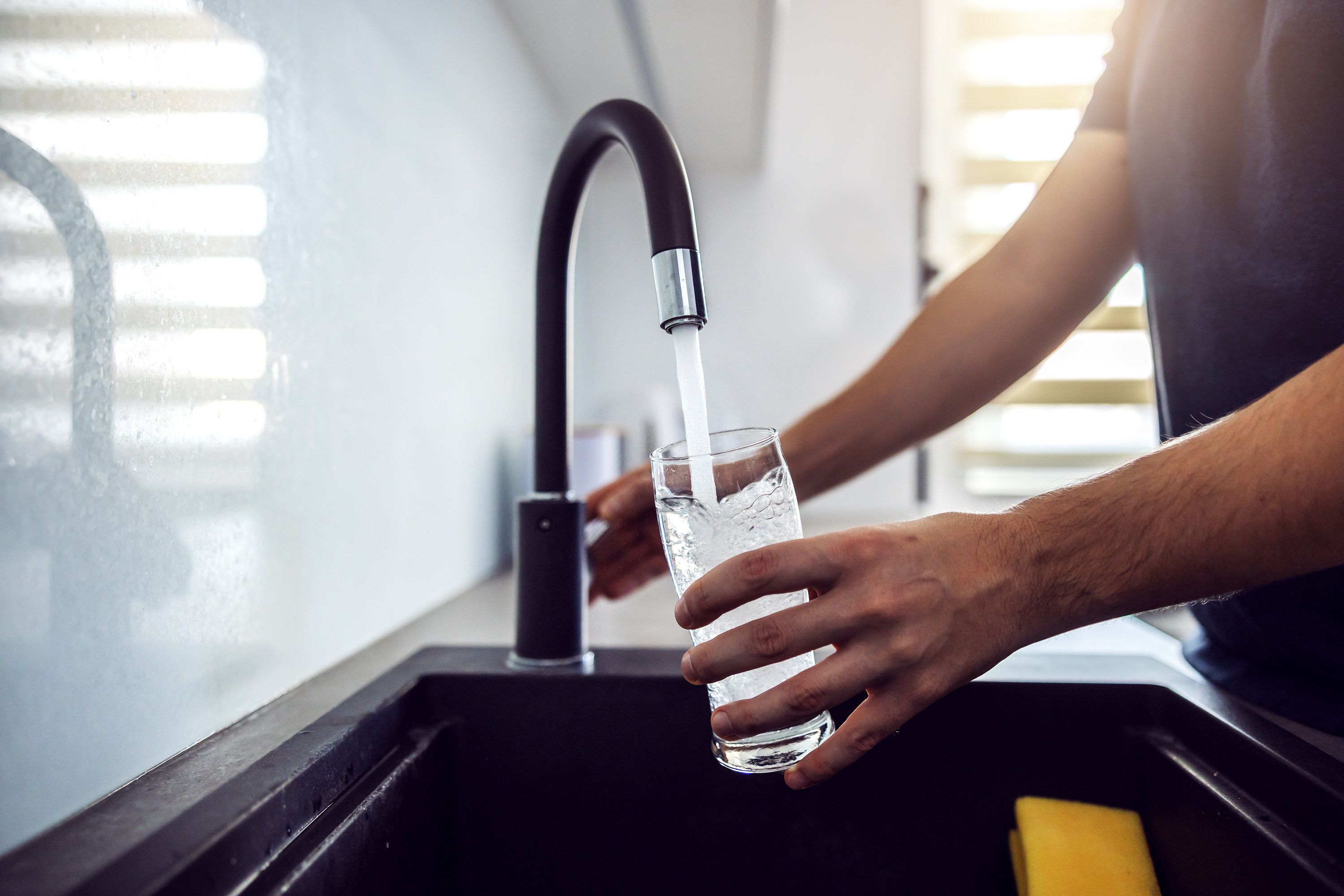 Filling a water glass at the sink