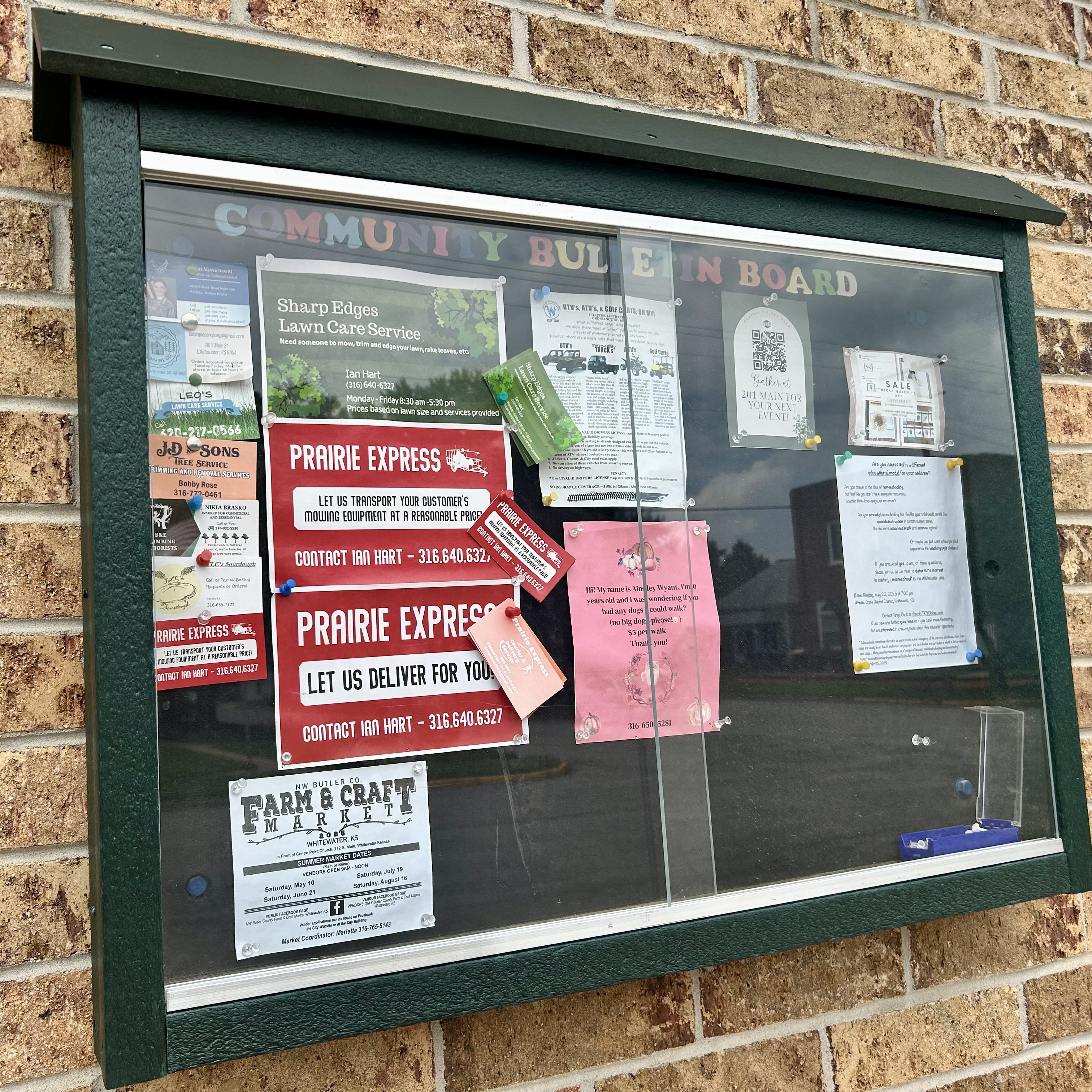 Flyers, business cards and more hung in an outdoor bulletin board